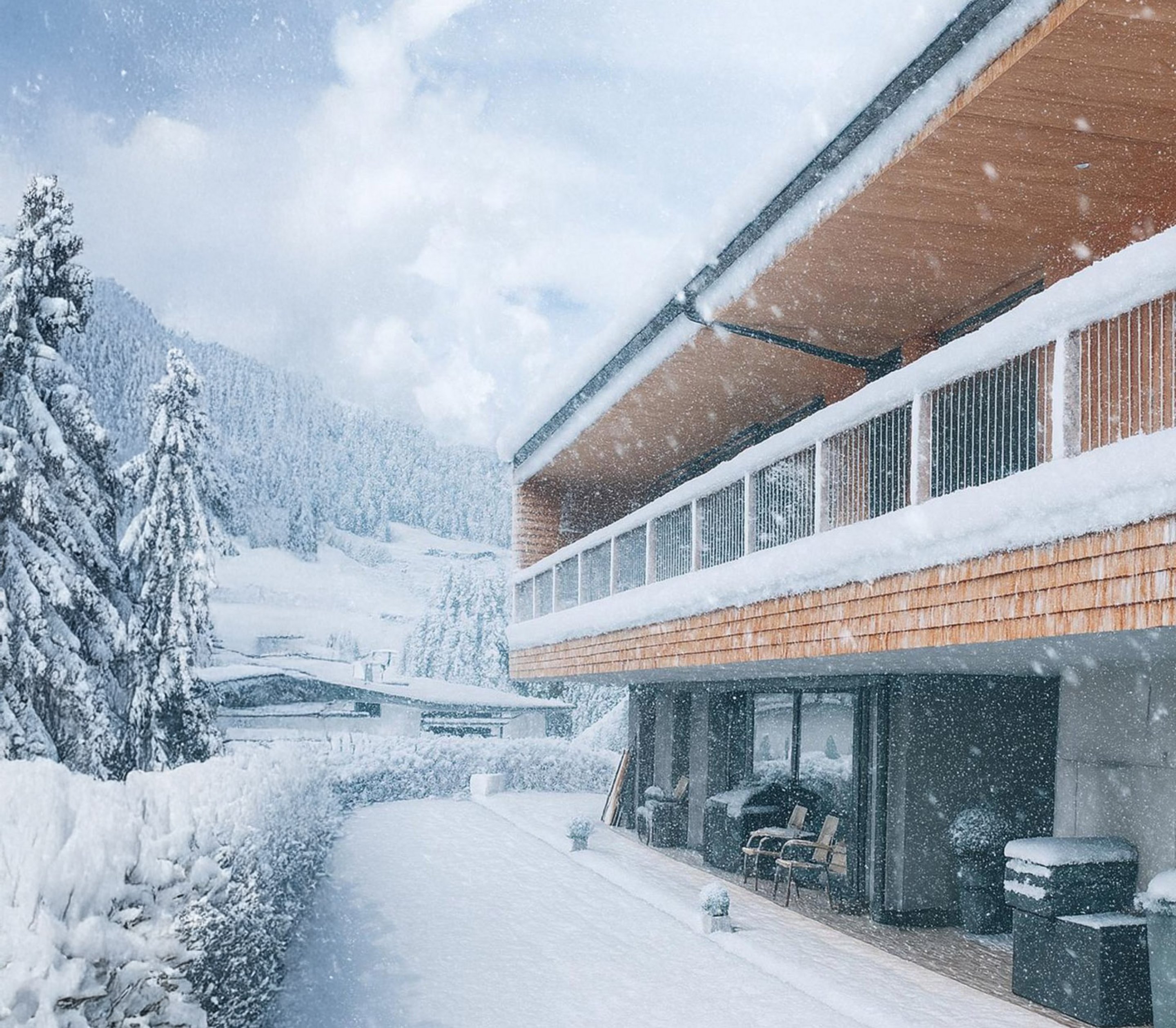 Chalet Wagrain - Schneebedeckt mit moderner Holzfassade und Balkonen in Wagrain bei Schneefall.